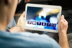 Man Using Smart Home Application In Tablet To Control House Royalty Free Stock Photo Man Using Smart Home Application In Tablet To Control House Royalty Free Stock Photo