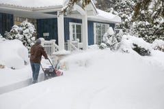 Man using snowblower in deep snow stock image Man using snowblower in deep snow stock image