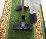 The man vacuums the carpet royalty free stock photography The man vacuums the carpet royalty free stock photography
