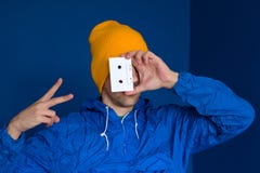 man in vintage blue jacket and yellow hat with audio tape stock photo man in vintage blue jacket and yellow hat with audio tape stock photo