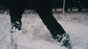 Man Walking in the Deep Snow in the Winter Forest at Snowy Day. Slow Motion