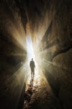 Man walking out of a cave into the light