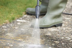 Man Washing Concrete Path With Pressure Washer royalty free stock photo Man Washing Concrete Path With Pressure Washer royalty free stock photo