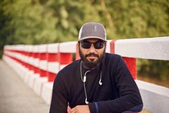 Man wearing a cap sitting in a place stock images Man wearing a cap sitting in a place stock images