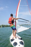 Man windsurfing on lake stock photo Man windsurfing on lake stock photo