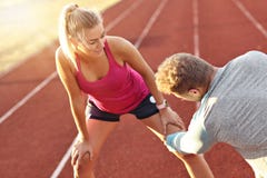 Man and woman racing on outdoor track stock image Man and woman racing on outdoor track stock image