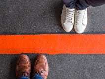 Close-up of people divided by a red line stock image Close-up of people divided by a red line stock image