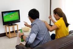 Man and woman watch Football match on tv Royalty Free Stock Photography Man and woman watch Football match on tv Royalty Free Stock Photography
