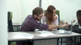 Man and woman work in comfortable modern office with laptop. Working process stock footage Man and woman work in comfortable modern office with laptop. Working process stock footage