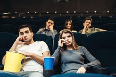 https://thumbs.dreamstime.com/t/man-women-popcorn-cinema-boring-film-concept-couple-watching-movie-118061966.jpg