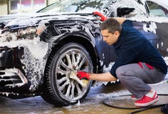 Man worker on a car wash