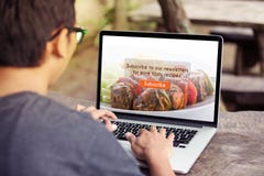 Man working on laptop / computer doing subscribe food blog on screen royalty free stock photos Man working on laptop / computer doing subscribe food blog on screen royalty free stock photos