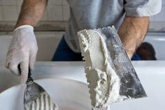 Man Working with Trowel and Mortar Tiling a Wall royalty free stock photography Man Working with Trowel and Mortar Tiling a Wall royalty free stock photography