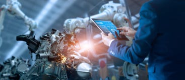 Manager engineer controlling automation robot arms machine royalty free stock image Manager engineer controlling automation robot arms machine royalty free stock image