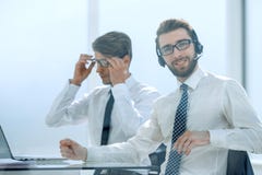 Manager with the headset works in a modern office stock photography Manager with the headset works in a modern office stock photography