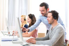 Manager training a young attractive people on computer stock image Manager training a young attractive people on computer stock image