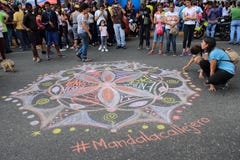 Mandala di disegno dei giovani per amore e pace nelle vie di Caracas durante il blackout del Venezuela fotografia stock libera da diritti Mandala di disegno dei giovani per amore e pace nelle vie di Caracas durante il blackout del Venezuela fotografia stock libera da diritti