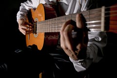 Mani del chitarrista ed alto vicino della chitarra Gioco della chitarra classica Giochi la chitarra fotografia stock libera da diritti Mani del chitarrista ed alto vicino della chitarra Gioco della chitarra classica Giochi la chitarra fotografia stock libera da diritti
