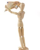 Manichino di legno che ispeziona una banconota immagini stock Manichino di legno che ispeziona una banconota immagini stock