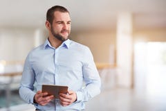 Mann mit dem Tablet-Computer, der zur Seite im Gesch?ftszentrum schaut stockbilder Mann mit dem Tablet-Computer, der zur Seite im Gesch?ftszentrum schaut stockbilder
