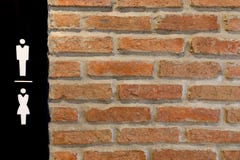 Mannelijke en vrouwelijke tekens op zwarte die achtergrond voor het toilet, toiletmuur van baksteen, Achtergrond van bakstenen mu royalty-vrije stock afbeelding Mannelijke en vrouwelijke tekens op zwarte die achtergrond voor het toilet, toiletmuur van baksteen, Achtergrond van bakstenen mu royalty-vrije stock afbeelding