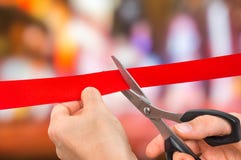 Mano con le forbici che tagliano nastro rosso - cerimonia di apertura Fotografia Stock Mano con le forbici che tagliano nastro rosso - cerimonia di apertura Fotografia Stock