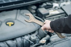 Mano del meccanico con una chiave Riparazione dell'automobile Mano con la chiave Meccanico nella riparazione dell'automobile fotografie stock Mano del meccanico con una chiave Riparazione dell'automobile Mano con la chiave Meccanico nella riparazione dell'automobile fotografie stock