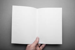 Manual start of white log with mockups of blank pages. A person reading two-page books looks at the first person royalty free stock photo Manual start of white log with mockups of blank pages. A person reading two-page books looks at the first person royalty free stock photo