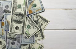 Many 100 dollar bills lying on the white background wood royalty free stock image Many 100 dollar bills lying on the white background wood royalty free stock image