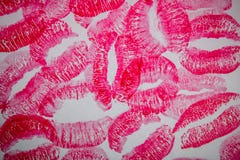 A lot of kissing marks made with the red lipstick on the white paper background - Image stock photos A lot of kissing marks made with the red lipstick on the white paper background - Image stock photos