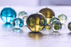 Many multicolored glass balls on a wooden surface. Royalty Free Stock Photography Many multicolored glass balls on a wooden surface. Royalty Free Stock Photography