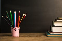 Many multicolored pencils in glass on wooden table with black background. Back to school concept stock images Many multicolored pencils in glass on wooden table with black background. Back to school concept stock images