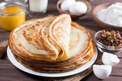 Many pancakes on a wooden background. Traditional Ukrainian or Russian pancakes. Shrovetide Maslenitsa. stock photos Many pancakes on a wooden background. Traditional Ukrainian or Russian pancakes. Shrovetide Maslenitsa. stock photos