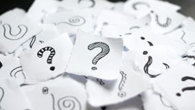 Many question marks on papers. Doodle drawn question marks on scraps of paper. Choice, decision making, assortment concept