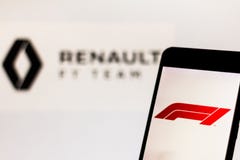 Official F1 FIA Formula 1 logo on the mobile device screen. Team Renault F1 Team logo on background royalty free stock photography Official F1 FIA Formula 1 logo on the mobile device screen. Team Renault F1 Team logo on background royalty free stock photography