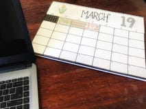 March 19 calendar on desk with laptop computer stock image March 19 calendar on desk with laptop computer stock image