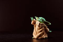 March, 2021: Display of Baby Yoda, an action figures. Stands on black background