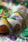 Mardi Gras: Traditional King Cake With Beads And Coins stock photography Mardi Gras: Traditional King Cake With Beads And Coins stock photography