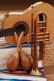 Mariachi. Accoustic guitar, maracas and trumpet on mexican fabric Mariachi. Accoustic guitar, maracas and trumpet on mexican fabric