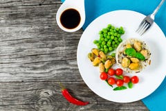 Marinated mussels with brown rice, cherry tomatoes, green peas royalty free stock images Marinated mussels with brown rice, cherry tomatoes, green peas royalty free stock images
