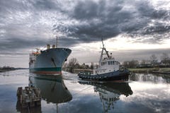 Maritime Tugboat Pulling A Cargo Ship On A Canal Royalty Free Stock Image Maritime Tugboat Pulling A Cargo Ship On A Canal Royalty Free Stock Image