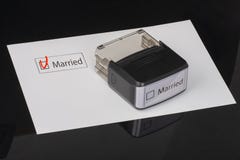 Married - checkbox with a cross on white paper with handle Rubber Stamper. Checklist concept stock photo Married - checkbox with a cross on white paper with handle Rubber Stamper. Checklist concept stock photo
