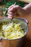 Mashing Boiled Potatoes Stock Images