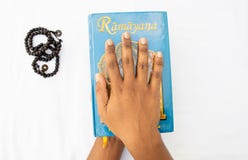 Maski,Karnataka,India - March 07,2019 : Holding of The Epic Hindu Mythology Ramayana book on isolated background stock photography Maski,Karnataka,India - March 07,2019 : Holding of The Epic Hindu Mythology Ramayana book on isolated background stock photography