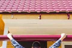 The master tries on the cornice to the roof stock photography The master tries on the cornice to the roof stock photography