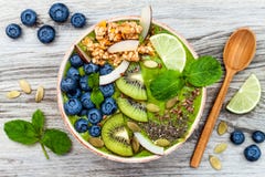 Matcha green tea breakfast superfoods smoothies bowl topped with chia, flax and pumpkin seeds, bee pollen, granola, coconut flakes stock photos Matcha green tea breakfast superfoods smoothies bowl topped with chia, flax and pumpkin seeds, bee pollen, granola, coconut flakes stock photos