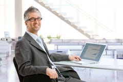 Mature businessman sitting at office desk royalty free stock photos Mature businessman sitting at office desk royalty free stock photos