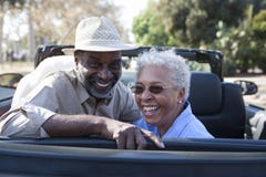 Mature Couple At The Back Seat Of Car Smiling Royalty Free Stock Images