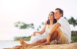 Mature Couple Enjoying Sunset on the Beach stock photography Mature Couple Enjoying Sunset on the Beach stock photography