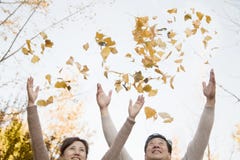 Mature Couple Throwing Leaves into the Air and Having Fun in in Autumn stock photography Mature Couple Throwing Leaves into the Air and Having Fun in in Autumn stock photography